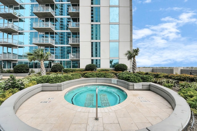 view of swimming pool with a community hot tub