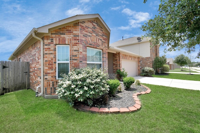 view of side of property with brick siding, a garage, driveway, and a yard