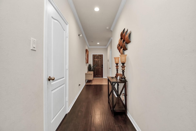 corridor featuring dark wood finished floors, recessed lighting, baseboards, and ornamental molding