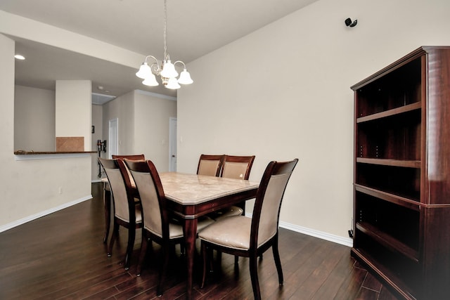 dining room featuring baseboards, an inviting chandelier, and dark wood-style flooring