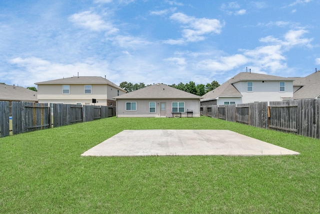 rear view of property with a patio, a lawn, and a fenced backyard