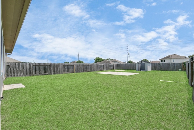 view of yard with a fenced backyard, a patio, a storage shed, and an outdoor structure