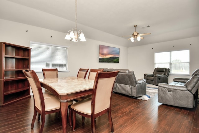 dining room with dark wood-style floors, visible vents, and ceiling fan with notable chandelier