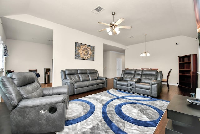 living room featuring visible vents, ceiling fan with notable chandelier, lofted ceiling, and wood finished floors