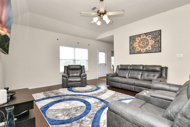 living area featuring wood finished floors, baseboards, visible vents, ceiling fan, and vaulted ceiling