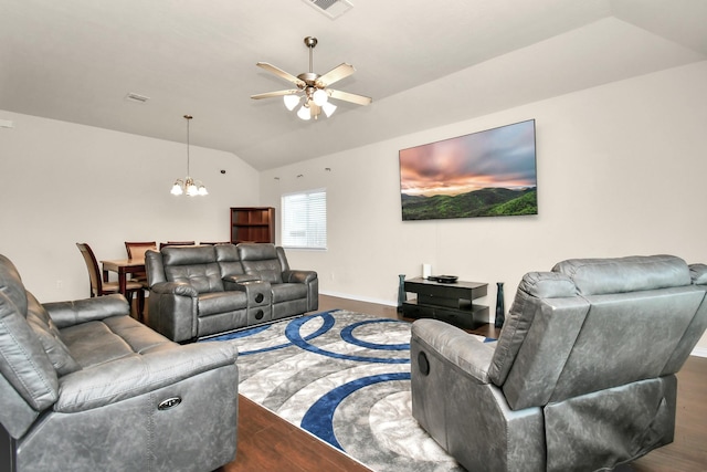 living room with visible vents, baseboards, lofted ceiling, ceiling fan with notable chandelier, and wood finished floors