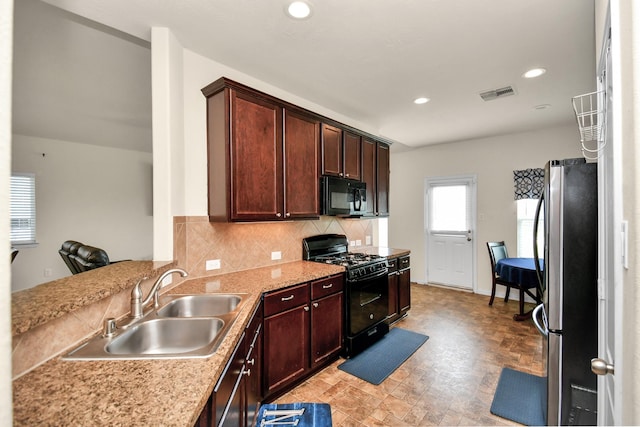 kitchen featuring visible vents, black appliances, a sink, recessed lighting, and decorative backsplash