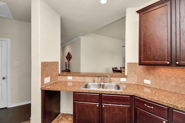 kitchen with a sink, visible vents, tasteful backsplash, and light countertops