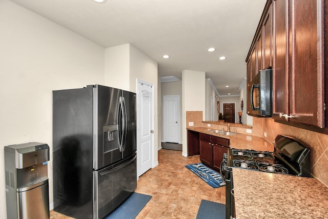 kitchen with black appliances, a sink, recessed lighting, dark brown cabinetry, and decorative backsplash