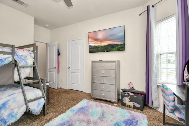 carpeted bedroom featuring visible vents and ceiling fan