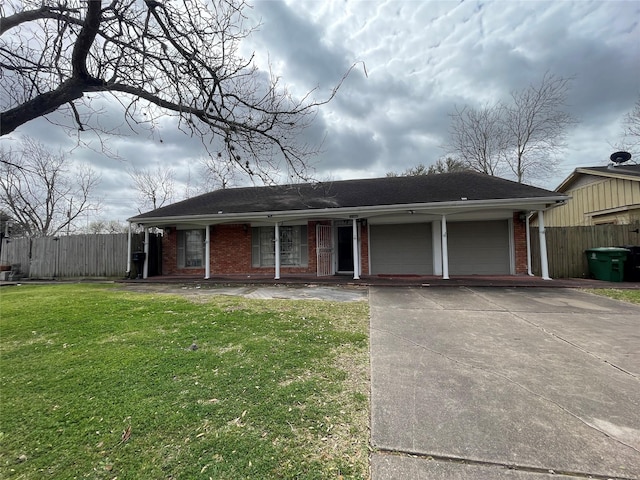 ranch-style house with driveway, brick siding, a front yard, and fence