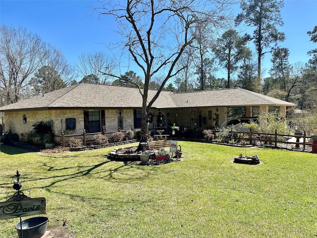 view of front of property featuring stone siding, a front yard, and fence