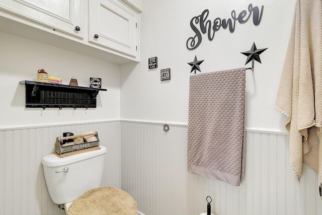 bathroom with toilet and wainscoting