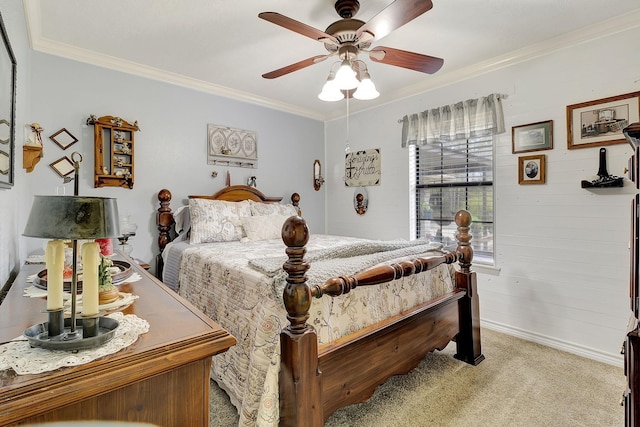 bedroom featuring light carpet, ornamental molding, and a ceiling fan