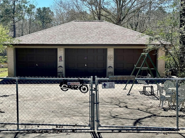 garage featuring a gate and fence