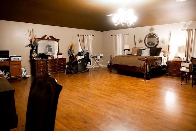 bedroom with visible vents, an inviting chandelier, baseboards, and light wood-style floors