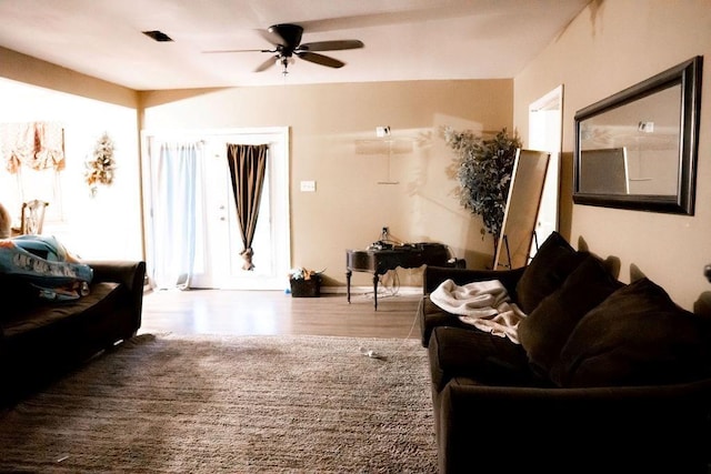 living area featuring a ceiling fan and wood finished floors