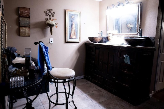 bathroom with tile patterned flooring, double vanity, and baseboards