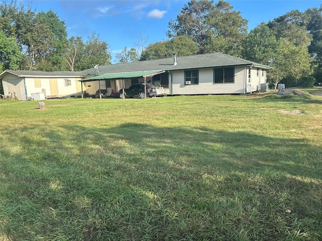 view of front of property featuring a carport, central AC, and a front yard