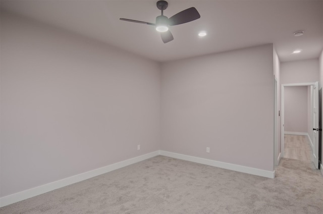 spare room with recessed lighting, baseboards, light carpet, and ceiling fan