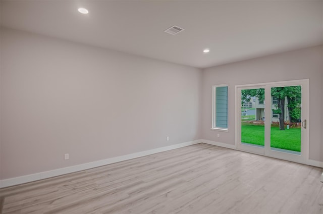 spare room featuring recessed lighting, light wood-style floors, visible vents, and baseboards