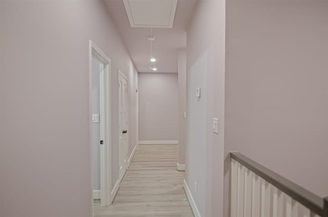 hall featuring baseboards, attic access, an upstairs landing, recessed lighting, and light wood-style floors