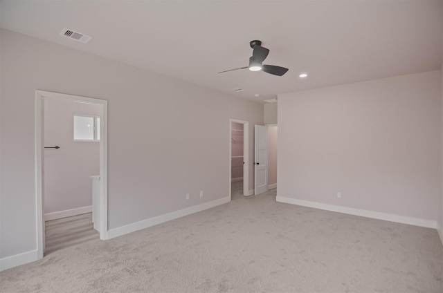 interior space with a spacious closet, visible vents, baseboards, and carpet floors