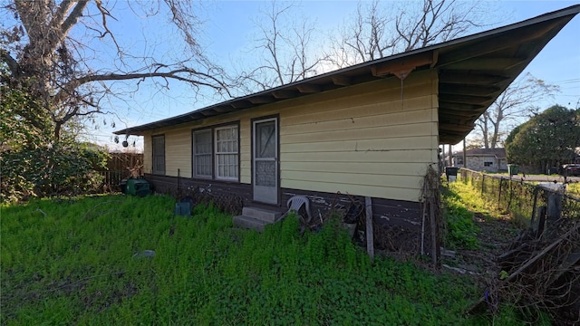 exterior space featuring entry steps and fence