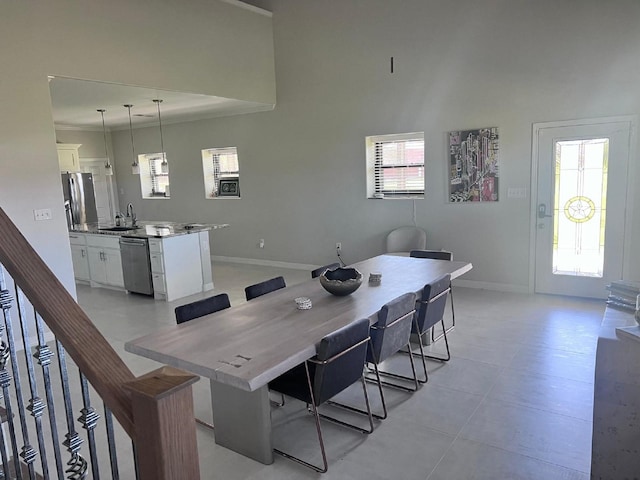 dining space with stairway, plenty of natural light, and baseboards