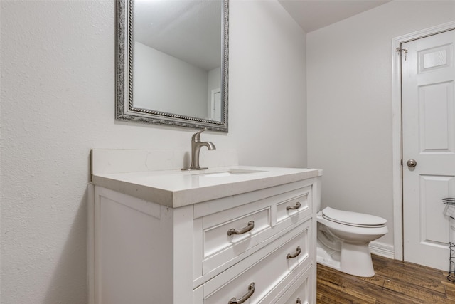 10711 Hidden Lake Ln, Richmond, TX 77406 - half bath featuring vanity, toilet, and wood finished floors