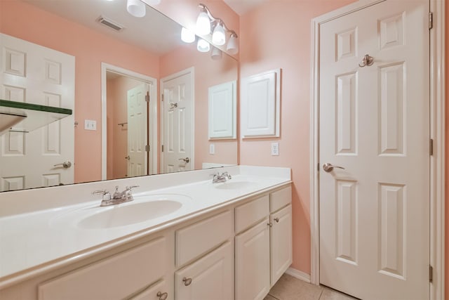 full bathroom featuring a sink, visible vents, double vanity, and tile patterned flooring