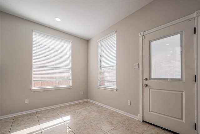 entryway featuring light tile patterned floors and baseboards