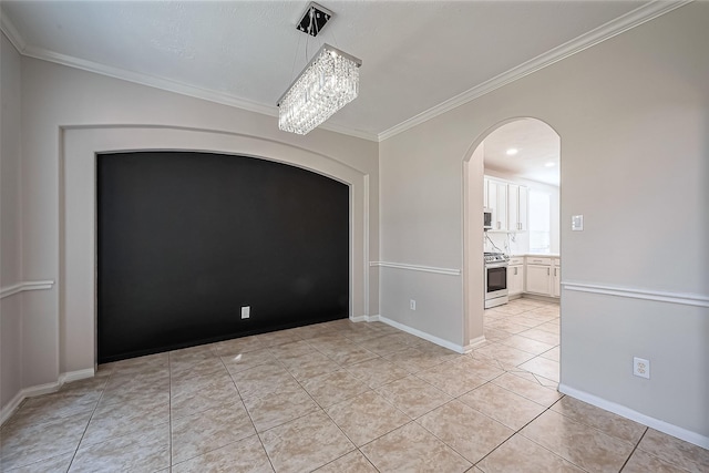 unfurnished dining area with crown molding, light tile patterned floors, arched walkways, and baseboards