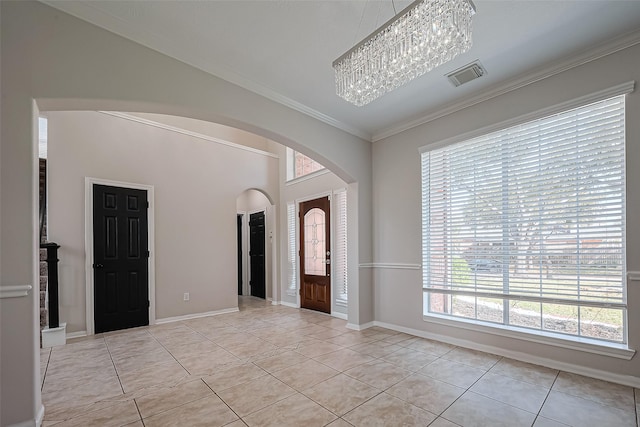 foyer featuring visible vents, arched walkways, light tile patterned flooring, crown molding, and a chandelier