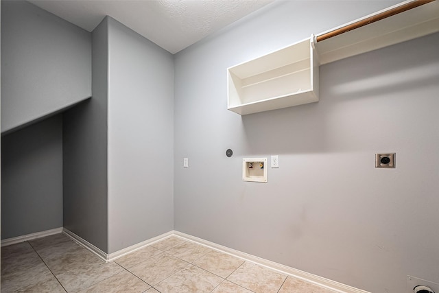 washroom featuring baseboards, light tile patterned floors, laundry area, hookup for a washing machine, and electric dryer hookup