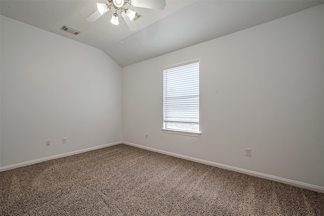 empty room featuring visible vents, baseboards, carpet, ceiling fan, and vaulted ceiling