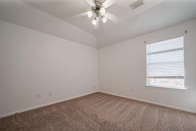 spare room with baseboards, visible vents, lofted ceiling, ceiling fan, and carpet flooring