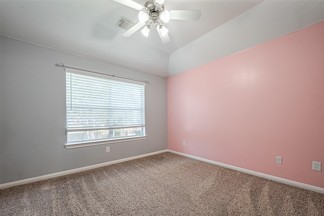 empty room featuring visible vents, baseboards, carpet, ceiling fan, and vaulted ceiling