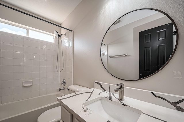 bathroom with shower / washtub combination, toilet, and vanity