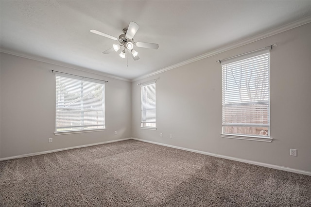 carpeted empty room featuring baseboards, crown molding, and a ceiling fan