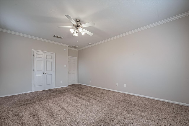 unfurnished bedroom featuring visible vents, baseboards, ornamental molding, carpet flooring, and a ceiling fan