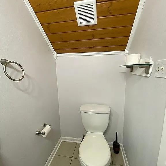 bathroom featuring tile patterned floors, visible vents, baseboards, and toilet