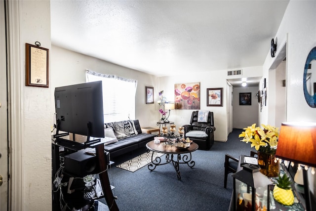 carpeted living room with visible vents and a textured ceiling