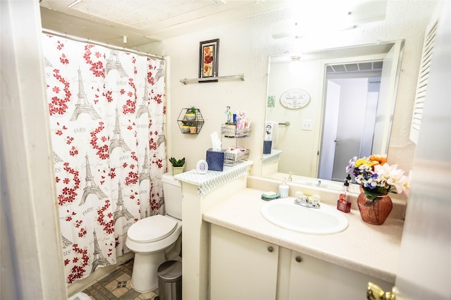 bathroom featuring curtained shower, toilet, and vanity