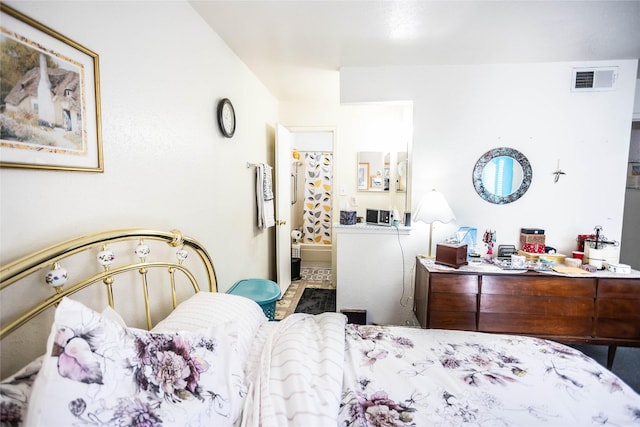 bedroom with visible vents and ensuite bathroom