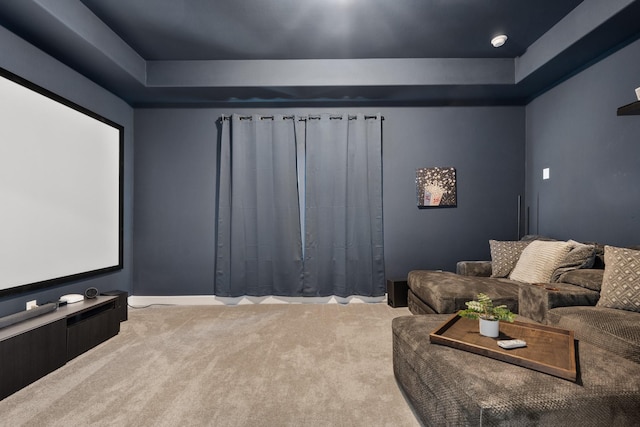 home theater with a raised ceiling and carpet floors