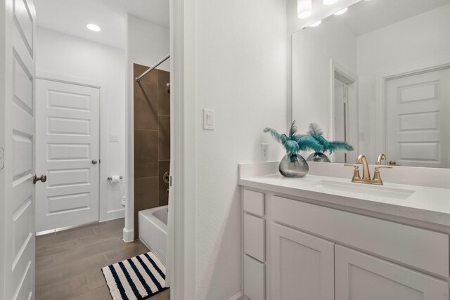 full bathroom with wood finish floors, recessed lighting, baseboards, bathing tub / shower combination, and vanity