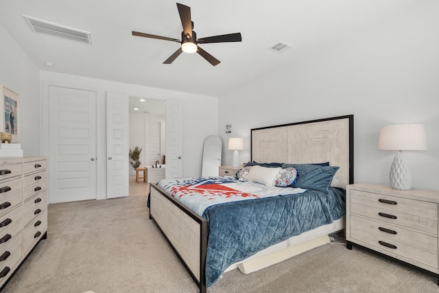 bedroom with a ceiling fan, visible vents, and light carpet