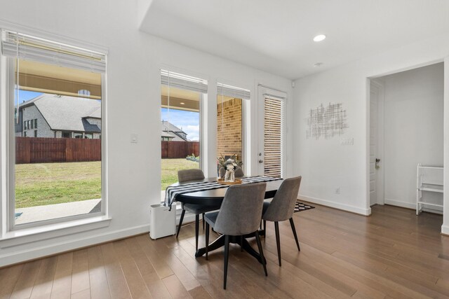 dining area with recessed lighting, baseboards, and wood finished floors