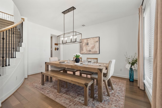 dining room with visible vents, stairway, wood finished floors, and baseboards